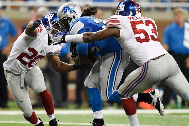 DETROIT, MI - SEPTEMBER 08: Joique Bell #35 of the Detroit Lions tries to break through the defense of Antrel Rolle #26 and Jameel McClain #53 of the New York Giants at Ford Field on September 8, 2014 in Detroit, Michigan. (Photo by Joe Sargent/Getty Images)
