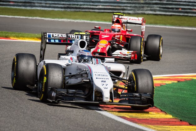 Williams driver Valtteri Bottas of Finland, front, and Ferrari driver Kimi Raikkonen of Finland steer their cars during the Belgian Formula One Grand Prix in Spa-Francorchamps, Belgium, Sunday, Aug. 24, 2014. Red Bull driver Daniel Ricciardo of Australia won the race, Mercedes driver Nico Rosberg of Germany finished second and Williams driver Valtteri Bottas of Finland third. (AP Photo/Geert Vanden Wijngaert)