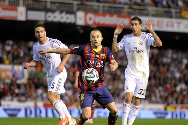VALENCIA, SPAIN - APRIL 16:  Andres Iniesta (C) of FC Barcelona gets past Angel Di Maria (R) and Daniel Carvajal of Real Madrid during the  Copa del Rey Final between Real Madrid and Barcelona at Estadio Mestalla on April 16, 2014 in Valencia, Spain.  (Photo by Denis Doyle/Getty Images)