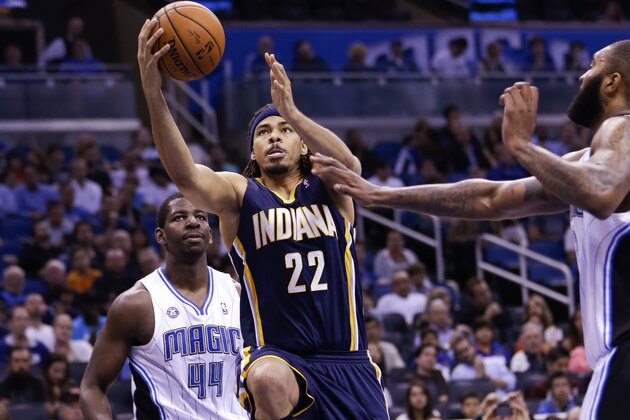 Indiana Pacers' Chris Copeland (22) drives to the basket for a shot as he gets past Orlando Magic's Andrew Nicholson (44) and Kyle O'Quinn, right, during the second half of an NBA basketball game in Orlando, Fla., Wednesday, April 16, 2014. Indiana won 101-86. (AP Photo/John Raoux)