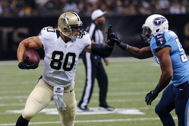 New Orleans Saints tight end Jimmy Graham (80) runs against Tennessee Titans middle linebacker Wesley Woodyard (59) after a reception in the first half of an NFL football game in New Orleans, Friday, Aug. 15, 2014. (AP Photo/Bill Haber)