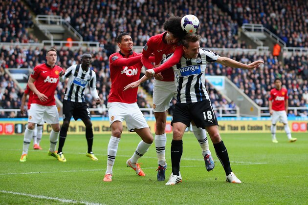 NEWCASTLE UPON TYNE, ENGLAND - APRIL 05: Chris Smalling and Marouane Fellaini of Manchester United put Luuk de Jong of Newcastle United under pressure during the Barclays Premier League match between Newcastle United and Manchester United  at St James' Park on April 5, 2014 in Newcastle upon Tyne, England.  (Photo by Jan Kruger/Getty Images)