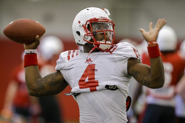 Nebraska quarterback Tommy Armstrong Jr. (4) throws during team practice in Lincoln, Neb., Wednesday, Aug. 13, 2014. Armstrong had never taken a meaningful snap when he was thrust into the Nebraska starting quarterback's job, and he helped lead the Cornhuskers to a nine-win season that ended with a bowl victory over Georgia. The sophomore knows expectations for him are much higher this season. (AP Photo/Nati Harnik)