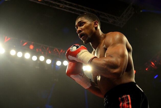 GLASGOW, SCOTLAND - MARCH 1 :  Anthony Joshua (black trunks) clashes with Hector Avila during an undercard bout at the WBO World Lightweight Championship Boxing match at the Glasgow SECC on March 1 2014 in Glasgow, Scotland. (Photo by Mark Runnacles/Getty Images)