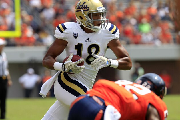 UCLA Bruins defensive back Jalen Ortiz (18) runs the ball in front of Virginia linebacker Tyler Shirley (42) during the second half of an NCAA college football game at Scott Stadium, Saturday, Aug. 30, 2014, in Charlottesville, Va. UCLA Bruins defeated Virginia 28-20. (AP Photo/Andrew Shurtleff)