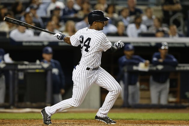 New York Yankees' Chris Young follows through on a fifth-inning RBI single in a baseball game against the Tampa Bay Rays at Yankee Stadium in New York, Tuesday, Sept. 9, 2014. (AP Photo/Kathy Willens)
