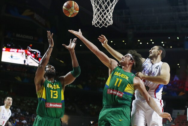 Brazil's Nene Hilario, left, Brazil's Anderson Varejao and Serbia's Nenad Krstic vie for the ball during the Basketball World Cup quarterfinal between Brazil and Serbia in Madrid, Spain, Wednesday, Sept. 10, 2014. The 2014 Basketball World Cup competition will take place in various cities in Spain from Aug. 30 through to Sept. 14. (AP Photo/Andres Kudacki)