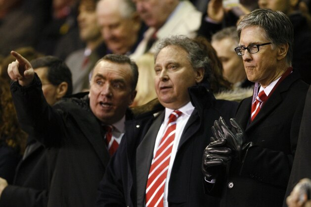 File -  Liverpool owner John W. Henry, right, and new Liverpool Managing Director Ian Ayre, left, look on before the second leg of their round of 16 Europa League soccer match between Liverpool and Braga at Anfield, Liverpool, England, on Thursday March 17, 2011. Liverpool's American owner has promoted  Ian Ayre the new managing director Tuesday March 22 2011.  Ayre replaces Christian Purslow, who oversaw Liverpool's sale from Tom Hicks and George Gillett Jr. to the Boston Red Sox ownership group in October.  (AP Photo/Tim Hales, file)