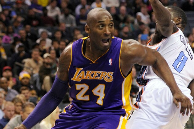 Dec 14, 2013; Charlotte, NC, USA; Los Angeles Lakers guard Kobe Bryant (24) drives to the basket as he is defended by Charlotte Bobcats guard Ben Gordon (8) during the first half of the game at Time Warner Cable Arena. Mandatory Credit: Sam Sharpe-USA TODAY Sports