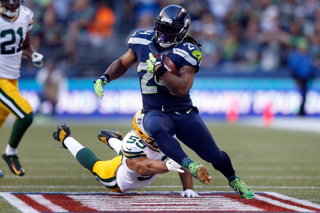 SEATTLE, WA - SEPTEMBER 04: Running back Marshawn Lynch #24 of the Seattle Seahawks runs with the ball as linebacker Brad Jones #59 of the Green Bay Packers dives in an attempt to catch him during the second quarter of the game at CenturyLink Field on September 4, 2014 in Seattle, Washington.  (Photo by Otto Greule Jr/Getty Images)