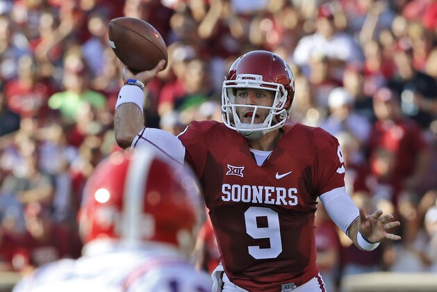 Oklahoma quarterback Trevor Knight (9) passes over a Louisiana Tech  defender in the first quarter of an NCAA college football game in Norman, Okla., Saturday, Aug. 30, 2014. (AP Photo/Sue Ogrocki)