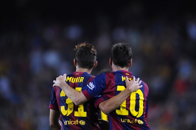 FC Barcelona's Lionel Messi from Argentina, right, reacts after scoring with his teammate Munir against Elche during a Spanish La Liga soccer match at the Camp Nou stadium in Barcelona, Spain, Sunday, Aug. 24, 2014. (AP Photo/Manu Fernandez)