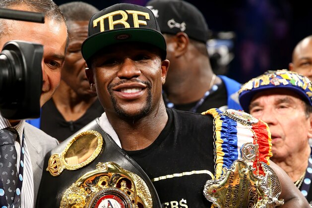 LAS VEGAS, NV - SEPTEMBER 14:  Floyd Mayweather Jr. celebrates his majority decision victory against Canelo Alvarez in their WBC/WBA 154-pound title fight at the MGM Grand Garden Arena on September 14, 2013 in Las Vegas, Nevada.  (Photo by Al Bello/Getty Images)