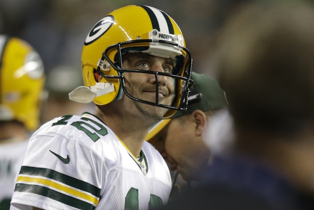 Green Bay Packers quarterback Aaron Rodgers looks at the scoreboard in the second half of an NFL football game against the Seattle Seahawks, Thursday, Sept. 4, 2014, in Seattle. (AP Photo/Stephen Brashear)