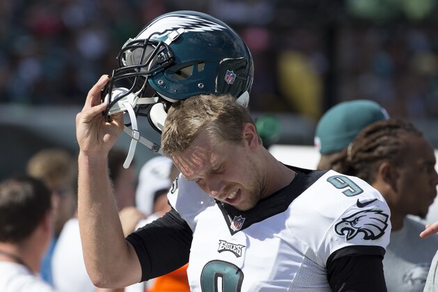 Philadelphia Eagles quarterback Nick Foles takes his helmet off during the second half of an NFL football game against the Jacksonville Jaguars, Sunday, Sept. 7, 2014, in Philadelphia. The Eagles won 34-17. (AP Photo/Chris Szagola)