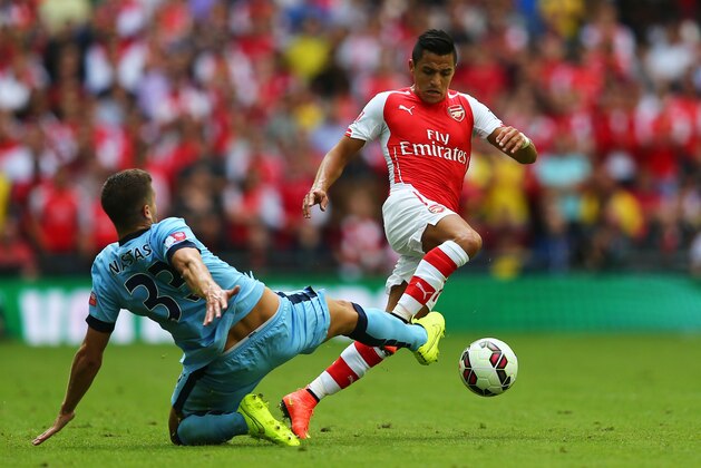 LONDON, ENGLAND - AUGUST 10:  Alexis Sanchez of Arsenal competes for the ball with Matija Nastasic of Manchester City during the FA Community Shield match Manchester City and Arsenal at Wembley Stadium on August 10, 2014 in London, England.  (Photo by Clive Mason/Getty Images)