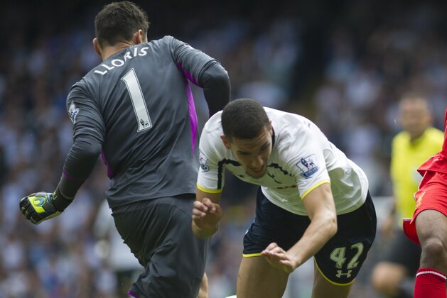 Tottenham Hotspur's Hugo Lloris, left, clears the ball in front of teammate Joshua Onomah, center, and Liverpool's Raheem Sterling, during their English Premier League soccer match at White Hart Lane, London, Sunday, Aug. 31, 2014 (AP Photo/Bogdan Maran) Tottenham Hotspur's Hugo Lloris, left, clears the ball in front of teammate Joshua Onomah, center, and Liverpool's Raheem Sterling, during their English Premier League soccer match at White Hart Lane, London, Sunday, Aug. 31, 2014 (AP Photo/Bogdan Maran)
