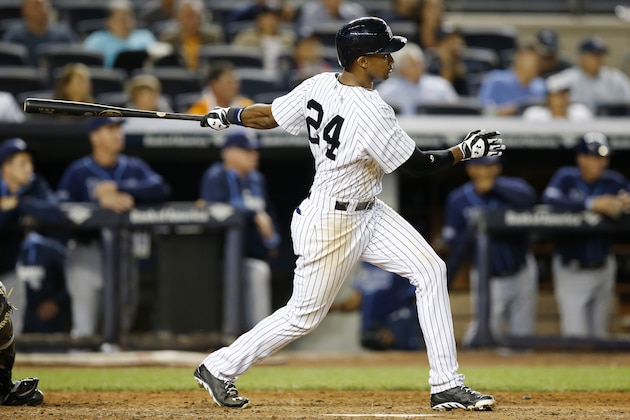 New York Yankees Chris Young hits an eighth-inning, RBI double in a baseball game against the Tampa Bay Rays at Yankee Stadium in New York, Wednesday, Sept. 10, 2014. Young went 3-4 in the game as the Yankees defeated the Rays 8-5. (AP Photo/Kathy Willens)