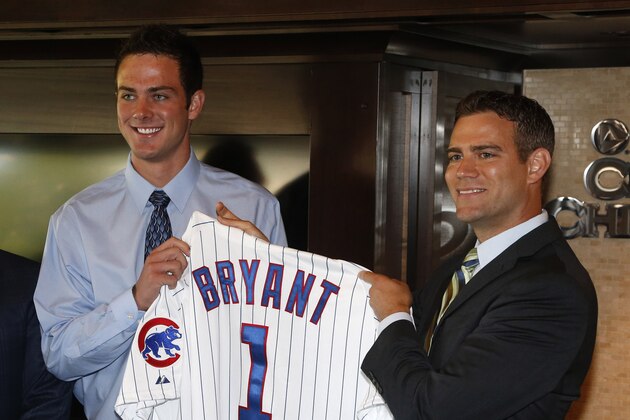 Chicago Cubs president of baseball operations Theo Epstein, right, poses with first-round draft pick, third baseman Kris Bryant during a news conference before a baseball game between the Chicago Cubs and the St. Louis Cardinals Friday, July 12 2013, in Chicago. (AP Photo/Charles Rex Arbogast)