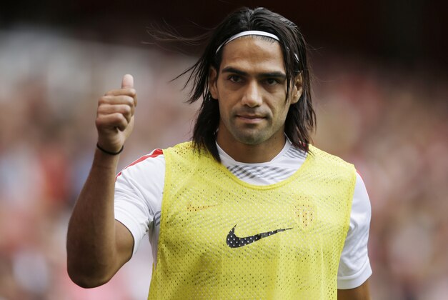 FILE - This is a Saturday, Aug. 2, 2014  file photo of AS Monaco player Radamel Falcao  as he gives a thumbs up to fans as he warms up on the sideline during the second half of the Emirates Cup soccer match between AS Monaco and Valencia at Arsenal's Emirates Stadium in London.  Radamel Falcao is set to join Manchester United on loan after the Premier League club agreed to a loan deal with Monaco, a person with knowledge of the deal said Monday Sept. 1, 2014.  (AP Photo/Matt Dunham, File)
