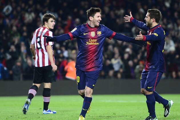 FC Barcelona's Lionel Messi, from Argentina, center, reacts after scoring with his teammates Jordi Alba, right, against Athletic Bilbao during a Spanish La Liga soccer match a at the Camp Nou stadium in Barcelona, Spain, Saturday, Dec. 1, 2012. (AP Photo/Manu Fernandez)