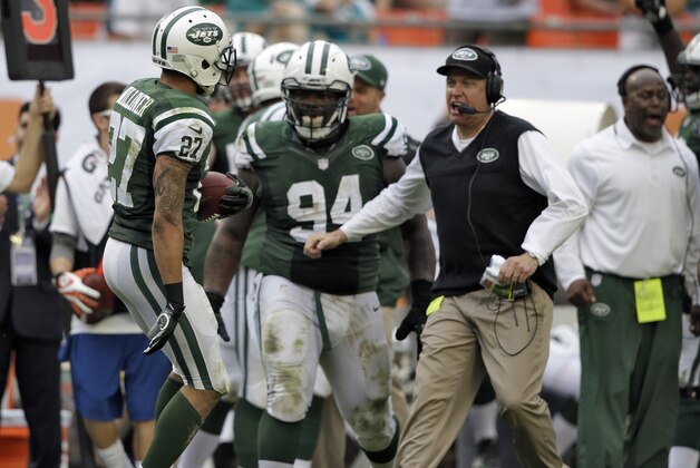 New York Jets head coach Rex Ryan, right, and nose tackle Damon Harrison (94) rush out to greet cornerback Dee Milliner after he interrupted a pass by Miami Dolphins quarterback Ryan Tannehill during the third quarter of an NFL football game Sunday, Dec. 29, 2013, in Miami Gardens, Fla. (AP Photo/Lynne Sladky)