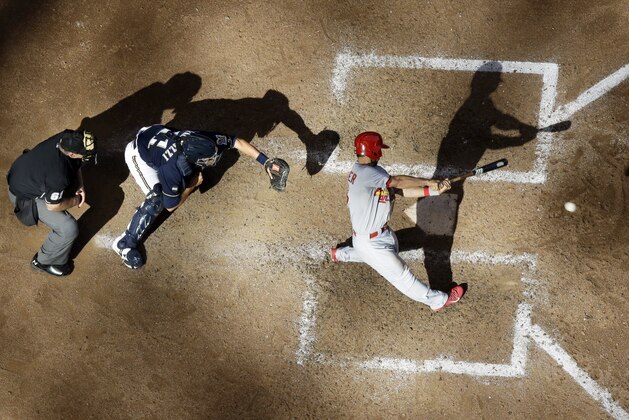 St. Louis Cardinals' Matt Carpenter hits an RBI single during the ninth inning of a baseball game against the Milwaukee Brewers Sunday, Sept. 7, 2014, in Milwaukee. (AP Photo/Morry Gash)