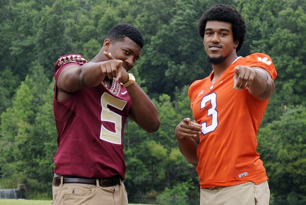 Jul 20, 2014; Greensboro, NC, USA; Florida State Seminloes quarterback Jameis Winston (5) and Clemson Tigers defensive end Vic Beasley (3) pose for a photo opportunity during the ACC Kickoff media day at the Grandover Resort. Mandatory Credit: Sam Sharpe-USA TODAY Sports