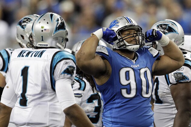Detroit Lions defensive tackle Ndamukong Suh (90) reacts after sacking Carolina Panthers quarterback Cam Newton (1) during the fourth quarter of an NFL football game in Detroit, Sunday, Nov. 20, 2011. Detroit won 49-35. (AP Photo/Carlos Osorio)