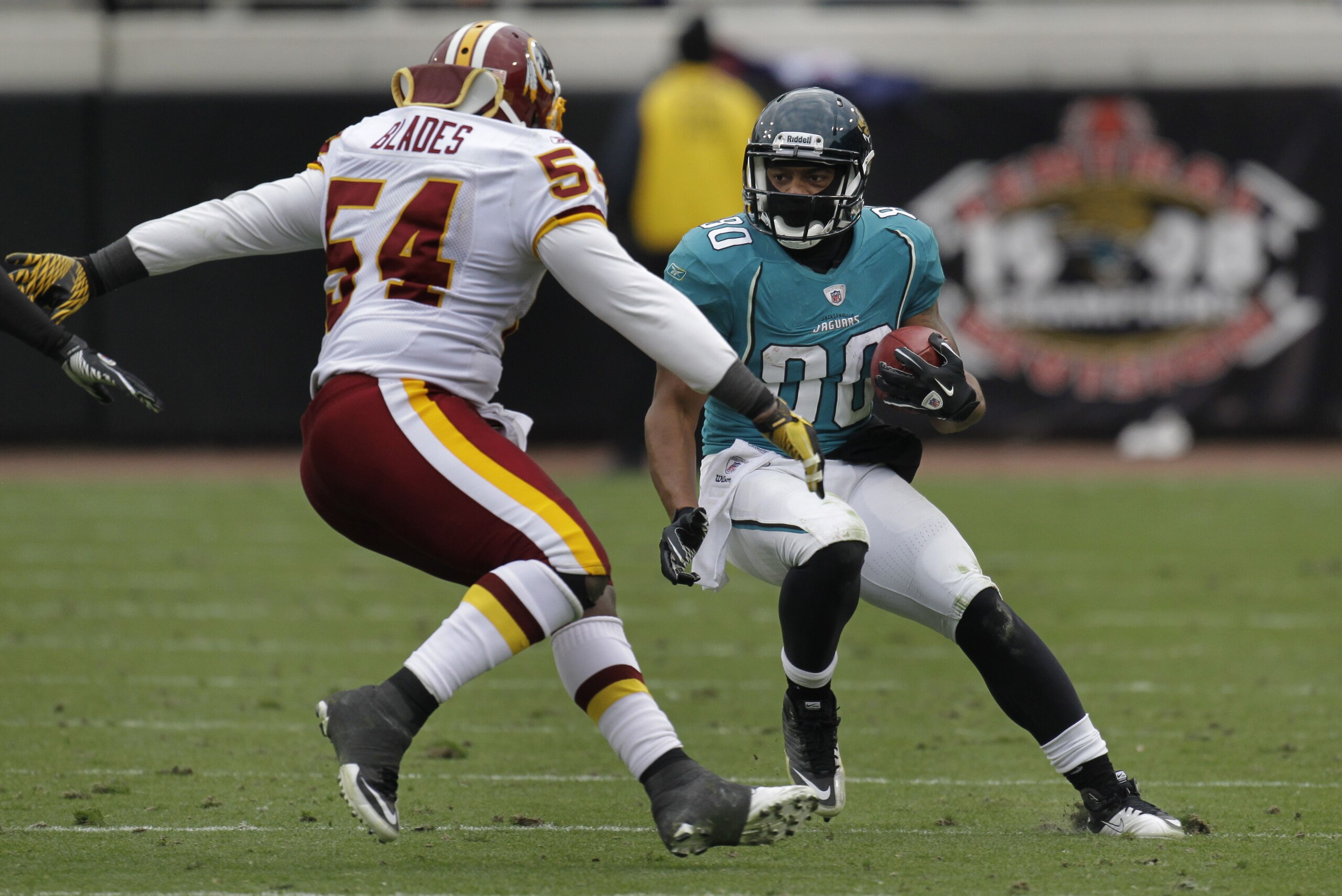 Jacksonville Jaguars wide receiver Mike Thomas tries to get around Washington Redskins linebacker H.B. Blades (54) during the second half of an NFL football game  in Jacksonville, Fla., Sunday, Dec. 26, 2010. Washington won 20-17 in overtime.(AP Photo/John Raoux)