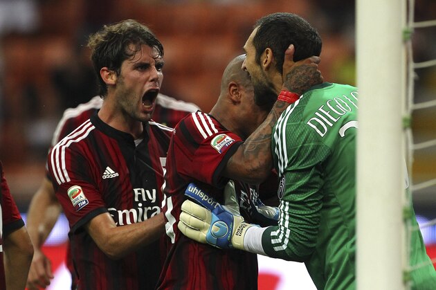 MILAN, ITALY - AUGUST 31:  AC Milan goalkeeper Diego Lopez (R) celebrates with his team-mates Nigel De Jong (C) and Andrea Poli (L) after saving a penalty during the Serie A match between AC Milan and SS Lazio at Stadio Giuseppe Meazza on August 31, 2014 in Milan, Italy.  (Photo by Marco Luzzani/Getty Images)