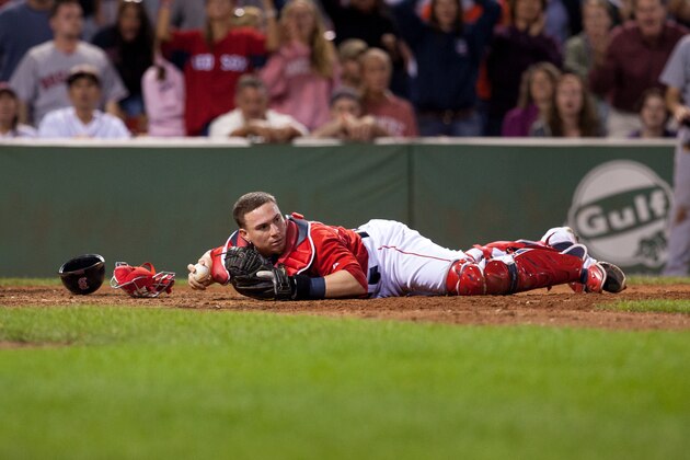 BOSTON, MA - AUGUST 22: Christian Vazquez #55 of the Boston Red Sox lays in the dirt after unsuccessfully tagging a player from the Seattle Mariners during the ninth inning at Fenway Park on August 22, 2014 in Boston, Massachusetts. The Mariners won 5-3 scoring all 5 runs in the ninth inning. (Photo by Rich Gagnon/Getty Images)