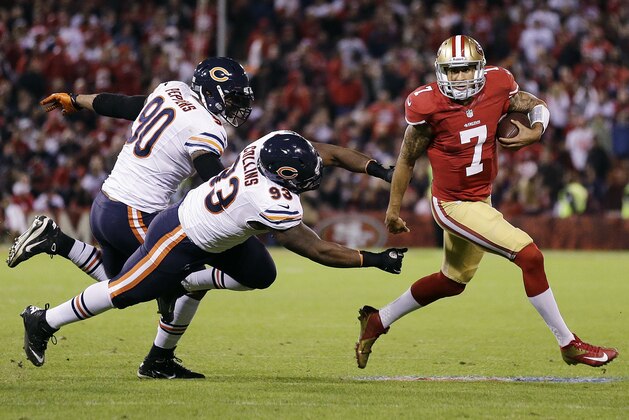 San Francisco 49ers quarterback Colin Kaepernick (7) runs away from Chicago Bears defensive end Julius Peppers (90) and defensive tackle Nate Collins (93) during the third quarter of an NFL football game in San Francisco, Monday, Nov. 19, 2012. (AP Photo/Marcio Jose Sanchez)