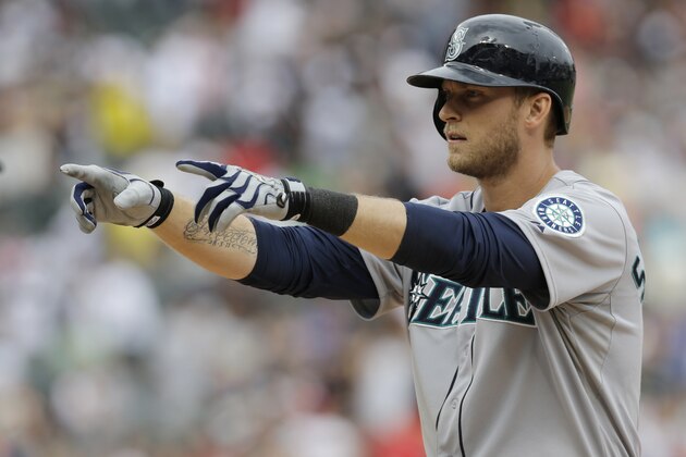 Seattle Mariners' Michael Saunders points to the dugout after hitting an one-run single during the ninth inning of a baseball game against the Chicago White Sox in Chicago on Saturday, July 5, 2014. (AP Photo/Nam Y. Huh)