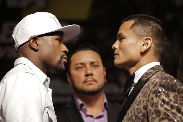 Boxers Floyd Mayweather Jr., left, and Marcos Maidana pose during a press conference Wednesday, Sept. 10, 2014, in Las Vegas. The two are scheduled to fight in a welterweight title fight Saturday in Las Vegas. (AP Photo/John Locher)