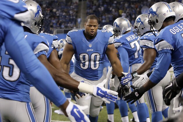 Detroit Lions defensive tackle Ndamukong Suh (90) is introduced before a preseason NFL football game against the Jacksonville Jaguars at Ford Field in Detroit, Friday, Aug. 22, 2014.  (AP Photo/Duane Burleson)
