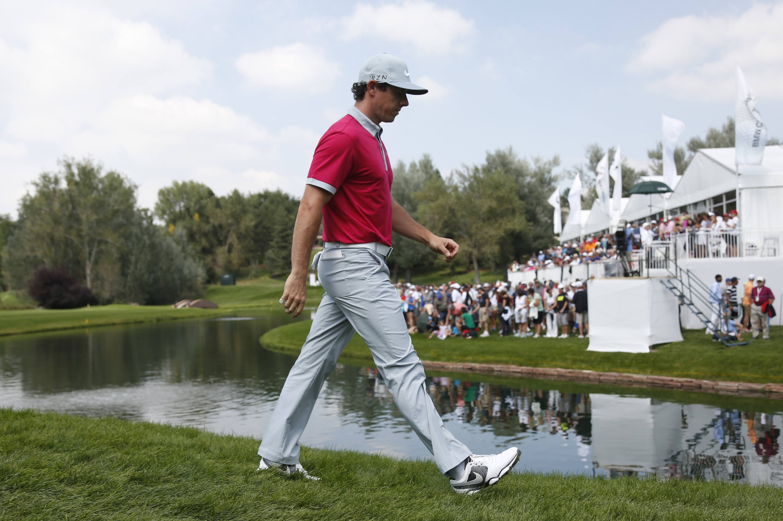 Rory McIlroy, of Northern Ireland, leaves the 12th green in the third round of the BMW Championship golf  tournament in Cherry Hills Village, Colo., on Saturday, Sept. 6, 2014. (AP Photo/David Zalubowski)