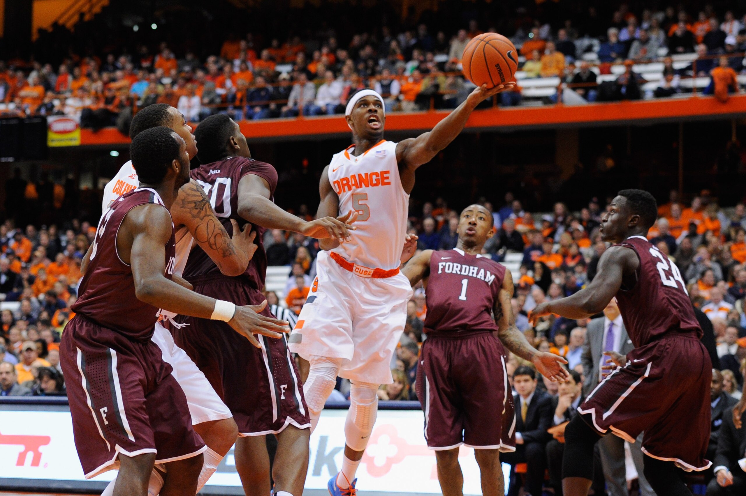 SYRACUSE, NY - NOVEMBER 12:  C.J. Fair #5 of the Syracuse Orange lays up a shot in front of Mandell Thomas #1 of the Fordham Rams during the first half at the Carrier Dome on November 12, 2013 in Syracuse, New York.  (Photo by Rich Barnes/Getty Images)
