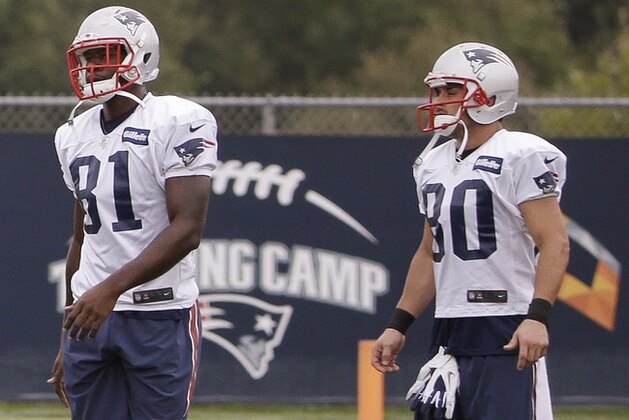 New England Patriots tight end Tim Wright (81) and wide receiver Danny Amendola (80) stand together during a stretching session before practice begins at the NFL football team's facility Thursday, Sept. 11, 2014, in Foxborough, Mass. (AP Photo/Stephan Savoia)