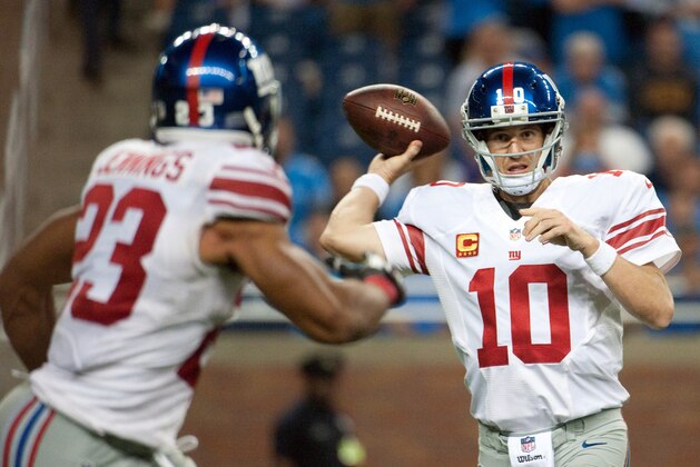 Sep 8, 2014; Detroit, MI, USA; New York Giants quarterback Eli Manning (10) passes to running back Rashad Jennings (23) during the fourth quarter against the Detroit Lions at Ford Field. Detroit won 35-14. Mandatory Credit: Tim Fuller-USA TODAY Sports