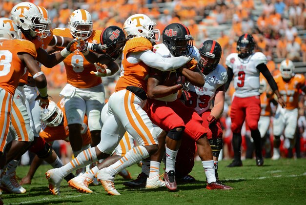 Sep 6, 2014; Knoxville, TN, USA; Arkansas State Red Wolves wide receiver DeKeathan Williams (26) is tackled by Tennessee Volunteers linebacker A.J. Johnson (45) during the second half at Neyland Stadium. Tennessee won 34 to 19. Mandatory Credit: Randy Sartin-USA TODAY Sports Sep 6, 2014; Knoxville, TN, USA; Arkansas State Red Wolves wide receiver DeKeathan Williams (26) is tackled by Tennessee Volunteers linebacker A.J. Johnson (45) during the second half at Neyland Stadium. Tennessee won 34 to 19. Mandatory Credit: Randy Sartin-USA TODAY Sports