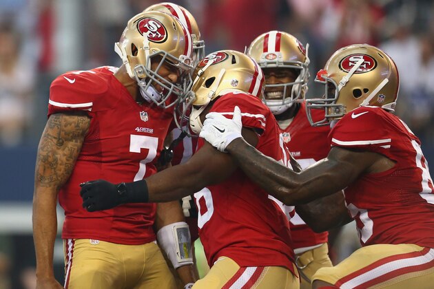 ARLINGTON, TX - SEPTEMBER 07:  (L-R)  Colin Kaepernick #7 celebrates a touchdown with  Carlos Hyde #28 against the Dallas Cowboys at AT&T Stadium on September 7, 2014 in Arlington, Texas.  (Photo by Ronald Martinez/Getty Images)