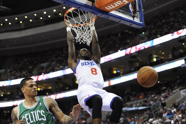 Philadelphia 76ers' Tony Wroten (8) scores on a dunks over Boston Celtics' Chris Babb during the first half of an NBA basketball game on Monday, April 14, 2014, in Philadelphia. (AP Photo/Michael Perez)