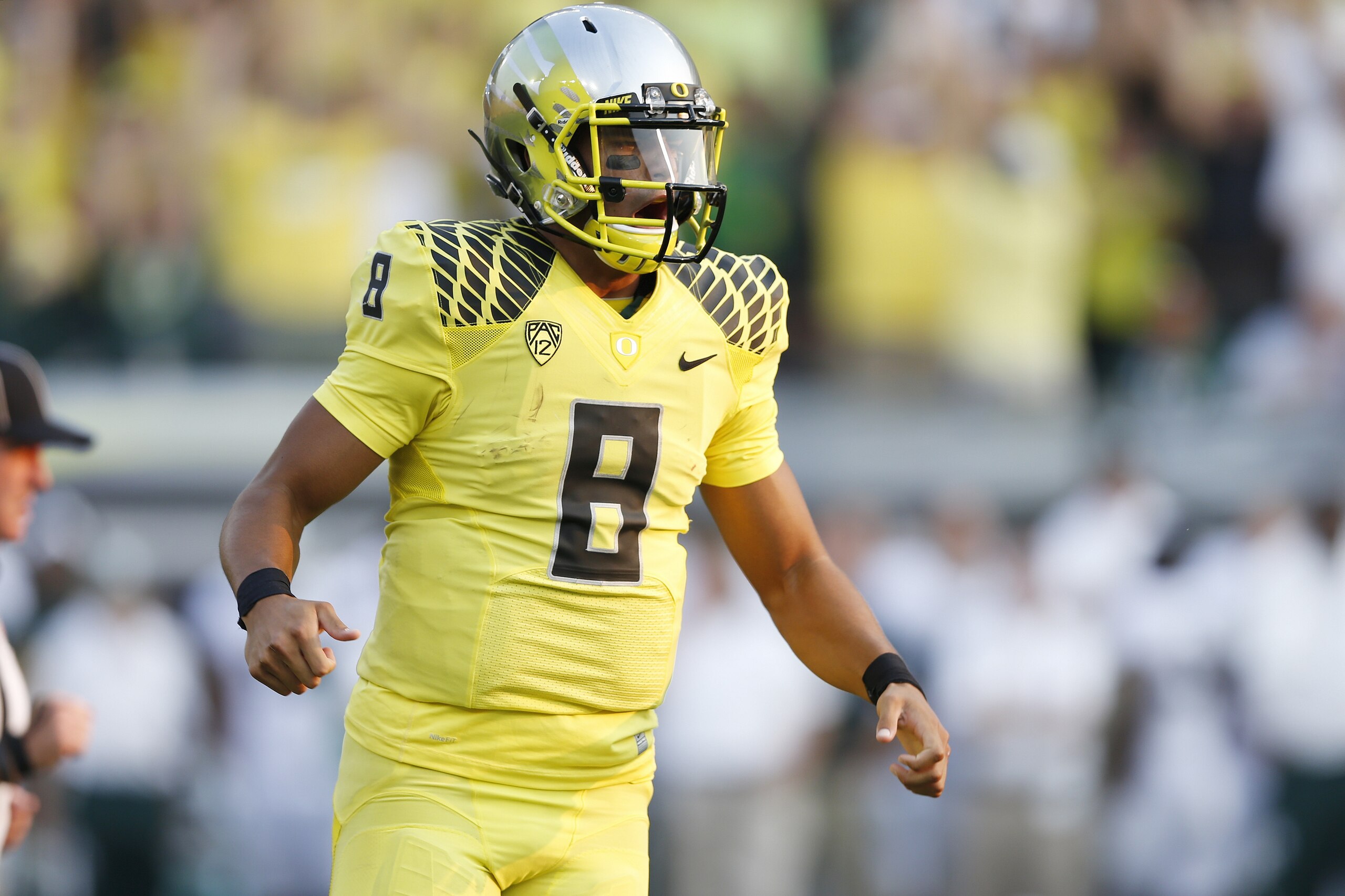 EUGENE, OR - SEPTEMBER 6: Marcus Mariota #8 of the Oregon Ducks celebrates after Royce Freeman rushed for a touchdown in the fourth quarter of the game against the Michigan State Spartans at Autzen Stadium on September 6, 2014 in Eugene, Oregon. Oregon won 46-27. (Photo by Joe Robbins/Getty Images) EUGENE, OR - SEPTEMBER 6: Marcus Mariota #8 of the Oregon Ducks celebrates after Royce Freeman rushed for a touchdown in the fourth quarter of the game against the Michigan State Spartans at Autzen Stadium on September 6, 2014 in Eugene, Oregon. Oregon won 46-27. (Photo by Joe Robbins/Getty Images)