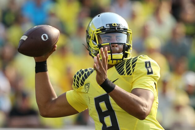 Oregon's Marcus Mariota passes down field against  Michigan State during the 2nd quarter of their college football game in Eugene, Ore. Saturday Sept. 6, 2014. (AP Photo/Chris Pietsch)