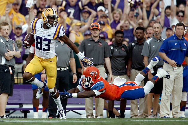 BATON ROUGE, LA - SEPTEMBER 06:  Travin Dural #83 of the LSU Tigers avoids a tackle by Mikell Everette #6 of the Sam Houston State Bearkats during the second quarter of a game at Tiger Stadium on September 6, 2014 in Baton Rouge, Louisiana.  (Photo by Stacy Revere/Getty Images)