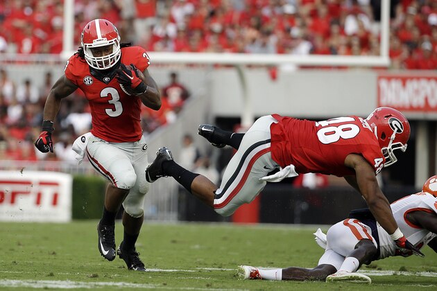 Georgia's Todd Gurley, left, runs the ball in the first half of an NCAA college football game against Clemson, Saturday, Aug. 30, 2014, in Athens, Ga. Georgia won 45-21. (AP Photo/David Goldman)