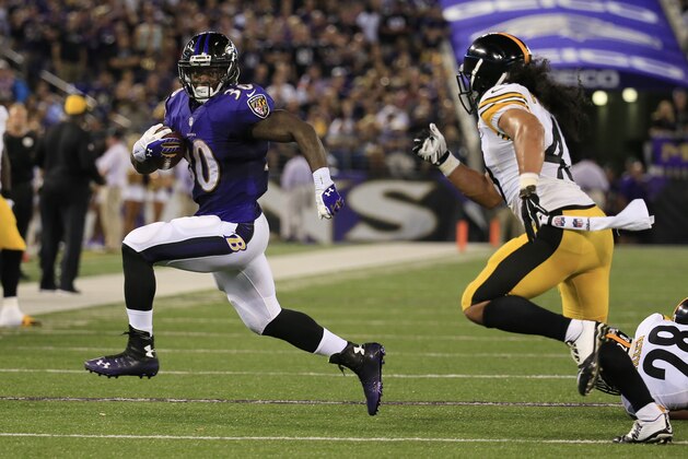 BALTIMORE, MD - SEPTEMBER 11: Running back Bernard Pierce #30 of the Baltimore Ravens evades strong safety Troy Polamalu #43 of the Pittsburgh Steelers at M&T Bank Stadium on September 11, 2014 in Baltimore, Maryland. (Photo by Rob Carr/Getty Images)