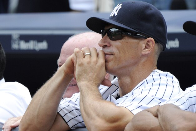 New York Yankees manager Joe Girardi looks on as Joe Torre has his number retired before a baseball game against the Chicago White Sox Saturday, Aug. 23, 2014, at Yankee Stadium in New York. (AP Photo/Bill Kostroun)