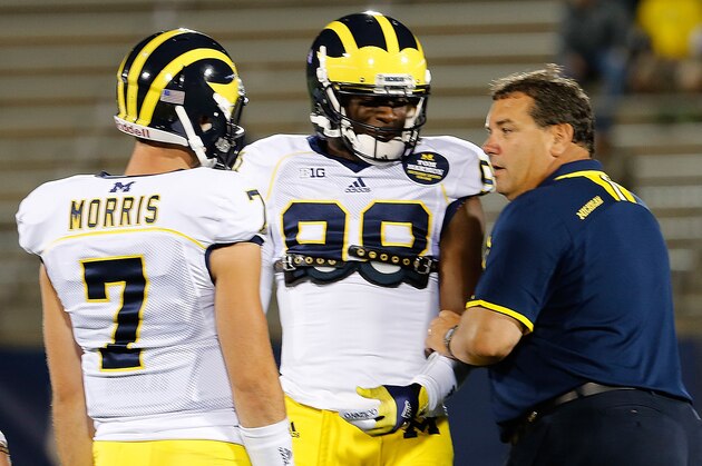 EAST HARTFORD, CT - SEPTEMBER 21:  Brady Hoke, coach of the Michigan Wolverines, talks with Devin Gardner #98 and Shane Morris #7 before a game with the Connecticut Huskies at Rentschler Field on September 21, 2013 in East Hartford, Connecticut.   (Photo by Jim Rogash/Getty Images)